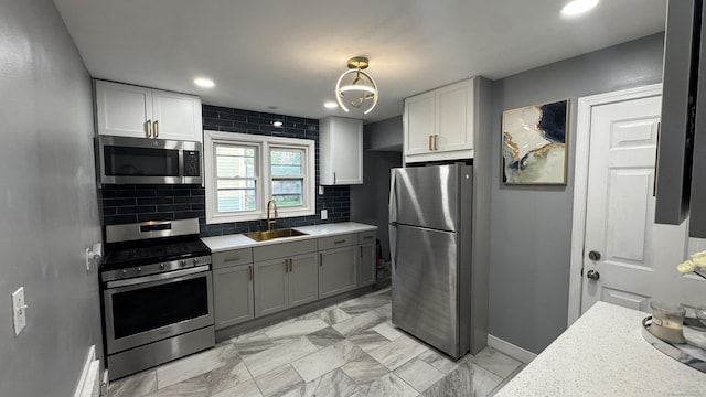 64 Locust St, Bridgeport, CT 06610 - kitchen with stainless steel appliances, a sink, light countertops, tasteful backsplash, and baseboards