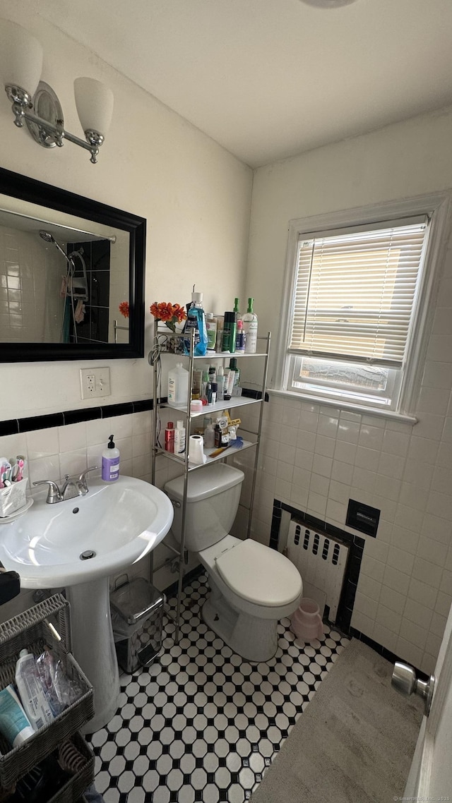 64 Locust St, Bridgeport, CT 06610 - bathroom featuring tile walls, radiator, toilet, and wainscoting