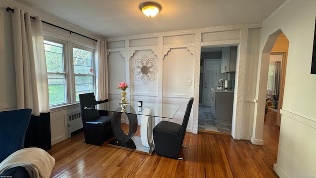 64 Locust St, Bridgeport, CT 06610 - dining room with radiator, wood finished floors, and arched walkways