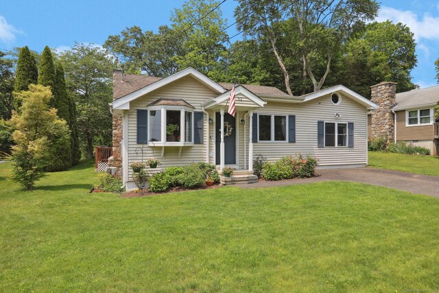 52 Berkshire Dr, Brookfield, CT 06804 - view of front of property with a chimney, a front yard, a shingled roof, and asphalt driveway