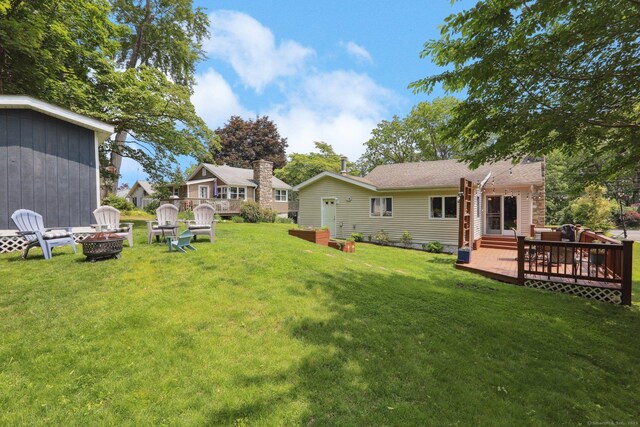 52 Berkshire Dr, Brookfield, CT 06804 - view of green lawn with a fire pit and a wooden deck