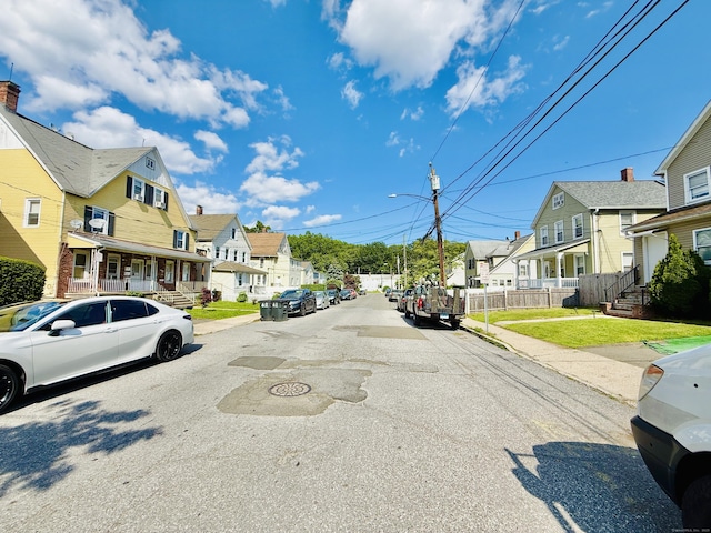 75 Frank St, Stamford, CT 06902 - view of asphalt street featuring a residential view, street lights, sidewalks, and curbs