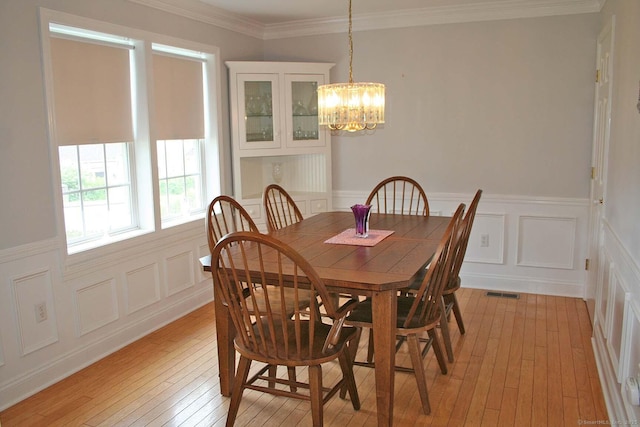 2 Cinnamon Ln Unit 2, Portland, CT 06480 - dining room featuring light wood-type flooring, a chandelier, wainscoting, a decorative wall, and crown molding