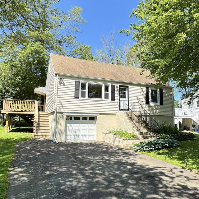98 N Atwater St, East Haven, CT 06512 - ranch-style house with stairs, driveway, an attached garage, and a deck