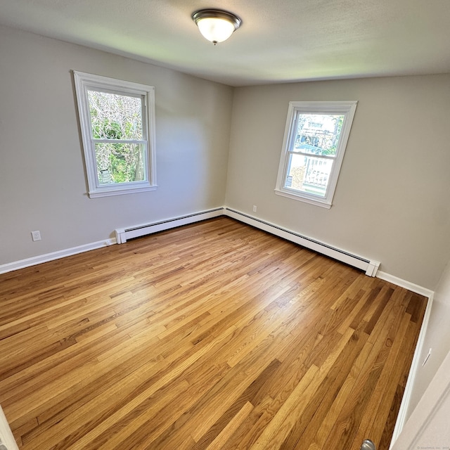 98 N Atwater St, East Haven, CT 06512 - unfurnished room featuring wood finished floors, a baseboard heating unit, and baseboards