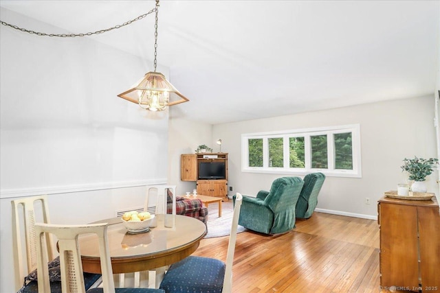 8 Fulton Dr, New Fairfield, CT 06812 - dining room with a chandelier, light wood finished floors, and baseboards