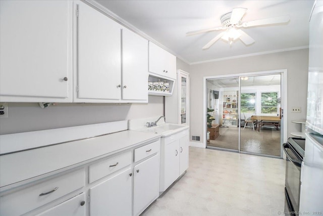 8 Fulton Dr, New Fairfield, CT 06812 - kitchen featuring stove, light countertops, ceiling fan, white cabinetry, and light floors