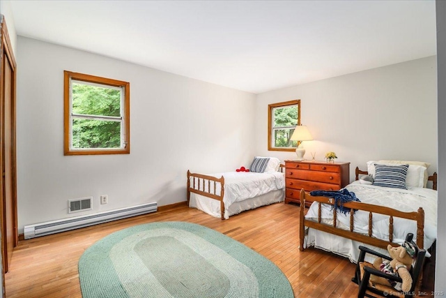 8 Fulton Dr, New Fairfield, CT 06812 - bedroom featuring multiple windows, light wood-style flooring, and baseboard heating