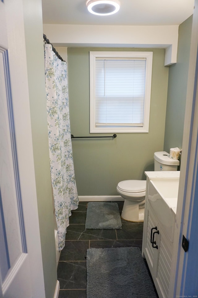 381 Oak St, East Hartford, CT 06118 - full bathroom with vanity, toilet, curtained shower, baseboards, and tile patterned floors
