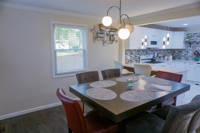 381 Oak St, East Hartford, CT 06118 - dining area featuring dark wood-style flooring, ornamental molding, and baseboards