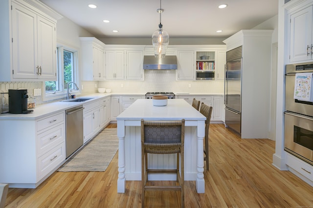 38 Old Trolley Rd, Ridgefield, CT 06877 - kitchen with a sink, wall chimney range hood, appliances with stainless steel finishes, a kitchen island, and backsplash