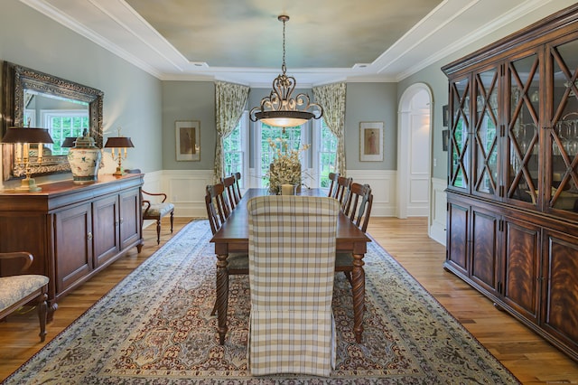 38 Old Trolley Rd, Ridgefield, CT 06877 - dining area with light wood-style floors, a raised ceiling, a wainscoted wall, a decorative wall, and arched walkways