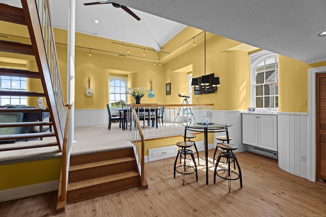 25 Orchard St Unit 14, Stonington, CT 06378 - kitchen with a ceiling fan, a wainscoted wall, light wood finished floors, white cabinets, and recessed lighting