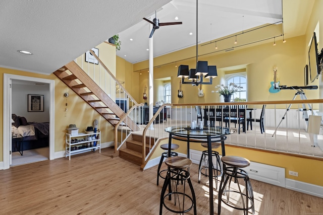 25 Orchard St Unit 14, Stonington, CT 06378 - dining room featuring stairway, wood finished floors, ceiling fan, and a chandelier