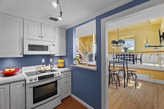 25 Orchard St Unit 14, Stonington, CT 06378 - kitchen with stainless steel electric range, white microwave, and white cabinets