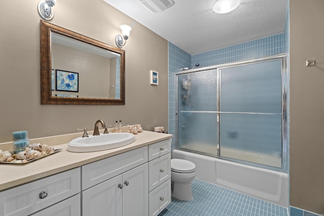 25 Orchard St Unit 14, Stonington, CT 06378 - full bath featuring vanity, tile patterned flooring, bath / shower combo with glass door, and a textured ceiling