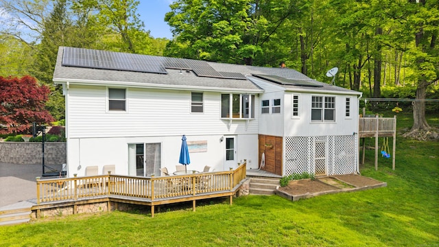 2 Pine Hill Rd, New Fairfield, CT 06812 - rear view of property featuring a wooden deck, a lawn, roof mounted solar panels, and roof with shingles