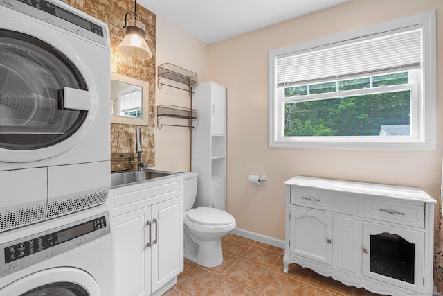 142 Summit St Unit 142, Norwich, CT 06360 - bathroom with stacked washer / dryer, tile patterned floors, toilet, and baseboards