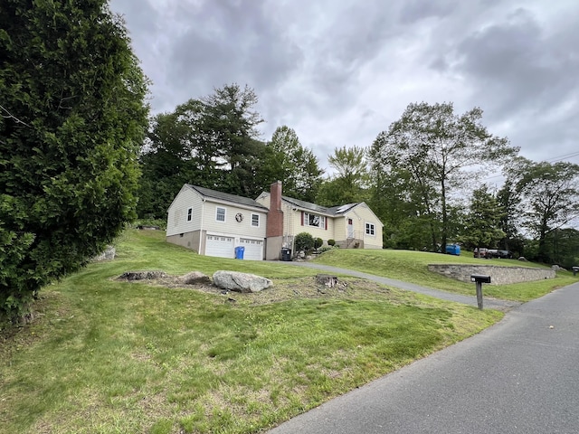 39 Eastwood Rd, Bristol, CT 06010 - view of front facade featuring a garage, a front lawn, driveway, and a chimney