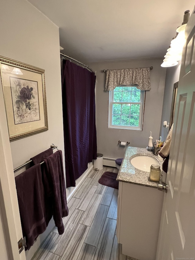 39 Eastwood Rd, Bristol, CT 06010 - full bathroom featuring a baseboard radiator, vanity, toilet, and wood tiled floors
