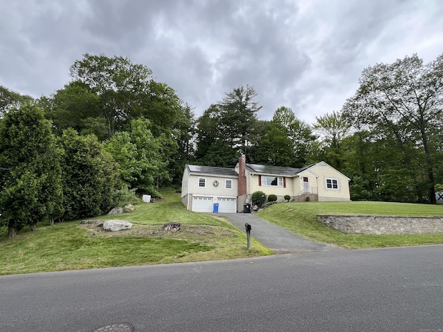 39 Eastwood Rd, Bristol, CT 06010 - view of front of house featuring asphalt driveway, a front yard, a chimney, and a garage