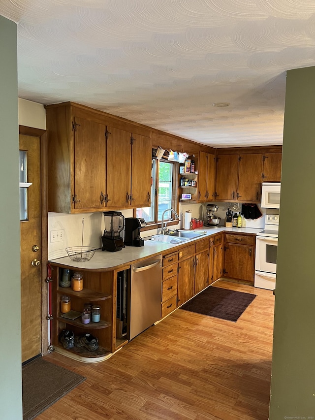 39 Eastwood Rd, Bristol, CT 06010 - kitchen with white appliances, a sink, open shelves, light wood-style flooring, and brown cabinetry