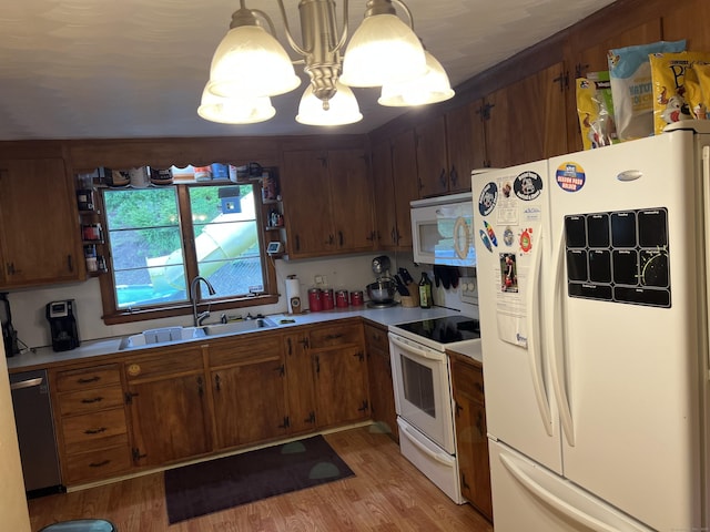 39 Eastwood Rd, Bristol, CT 06010 - kitchen with white appliances, a sink, light wood finished floors, and light countertops