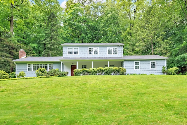6 Rivergate Woods, Wilton, CT 06897 - colonial-style house with a chimney and a front lawn