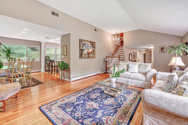 6 Rivergate Woods, Wilton, CT 06897 - living room with a baseboard heating unit, wood finished floors, stairway, vaulted ceiling, and baseboards