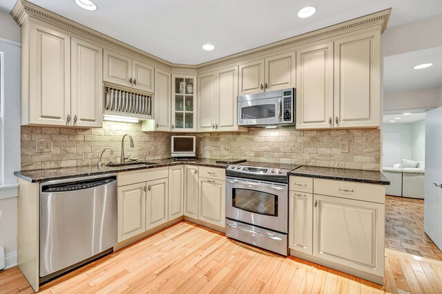 6 Rivergate Woods, Wilton, CT 06897 - kitchen featuring stainless steel appliances, a sink, cream cabinets, dark stone counters, and recessed lighting