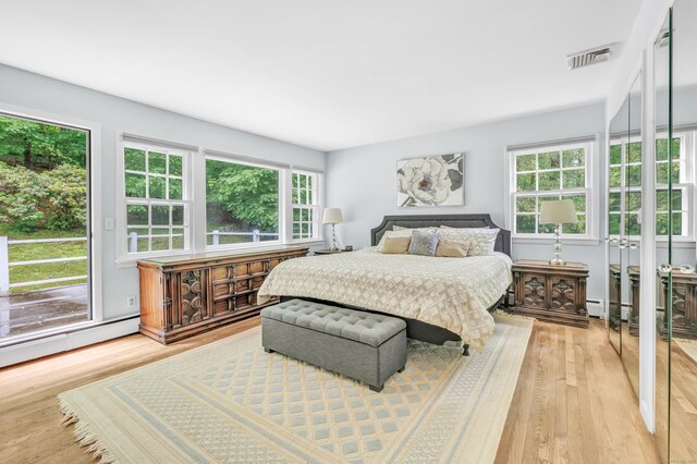 6 Rivergate Woods, Wilton, CT 06897 - bedroom with multiple windows, light wood finished floors, and a baseboard heating unit