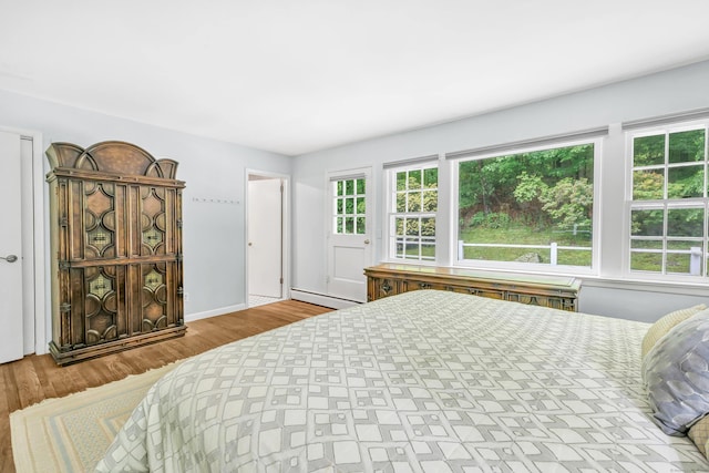 6 Rivergate Woods, Wilton, CT 06897 - bedroom featuring a baseboard heating unit, wood finished floors, and baseboards