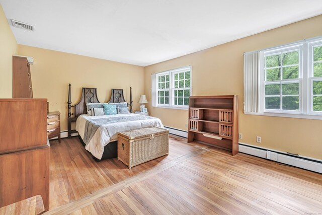 6 Rivergate Woods, Wilton, CT 06897 - bedroom featuring a baseboard heating unit and hardwood / wood-style flooring