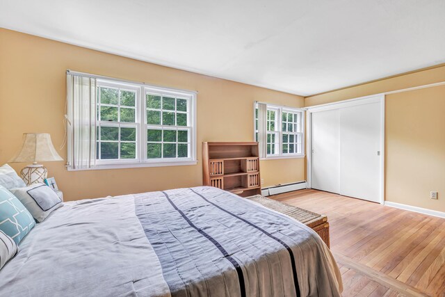 6 Rivergate Woods, Wilton, CT 06897 - bedroom with a baseboard heating unit, hardwood / wood-style floors, a closet, and baseboards