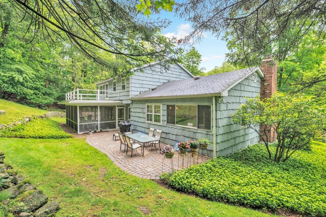 6 Rivergate Woods, Wilton, CT 06897 - rear view of house with a sunroom, a balcony, a patio, a chimney, and a lawn