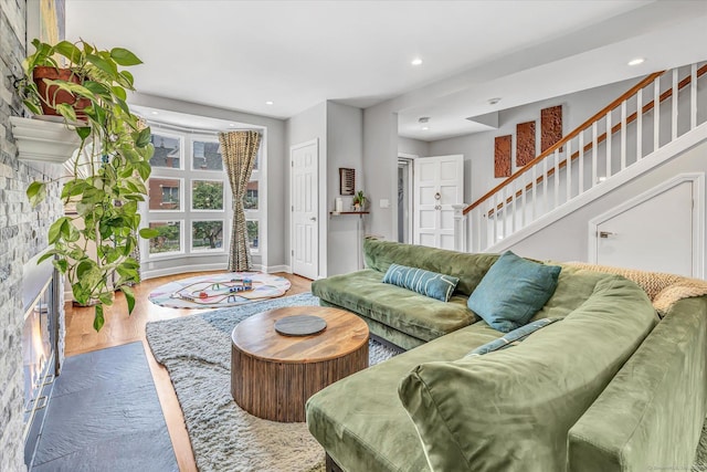 40 Temple Ct Unit 40, New Haven, CT 06511 - living room with wood finished floors, a glass covered fireplace, stairway, and recessed lighting