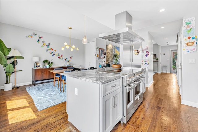40 Temple Ct Unit 40, New Haven, CT 06511 - kitchen with double oven range, island exhaust hood, light wood-style floors, light stone countertops, and white cabinets