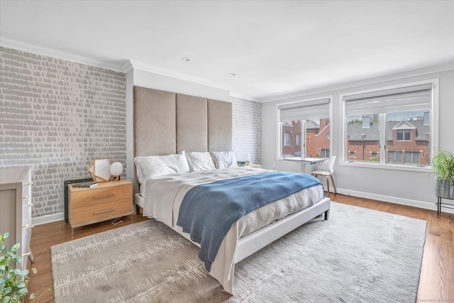 40 Temple Ct Unit 40, New Haven, CT 06511 - bedroom with ornamental molding, wood finished floors, wallpapered walls, and an accent wall