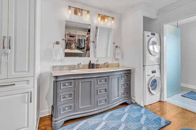 40 Temple Ct Unit 40, New Haven, CT 06511 - bathroom featuring stacked washer / drying machine, double vanity, wood finished floors, and ornamental molding