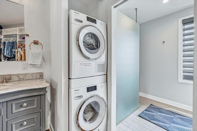 40 Temple Ct Unit 40, New Haven, CT 06511 - laundry room with estacked washer and dryer and light wood-style flooring