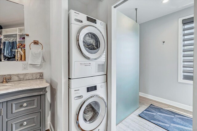 40 Temple Ct Unit 40, New Haven, CT 06511 - laundry room with estacked washer and dryer and light wood-style flooring