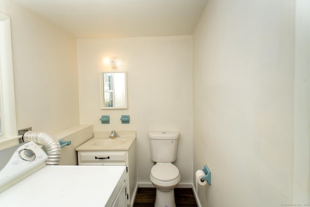 498 Long Hill Ave, Shelton, CT 06484 - half bath with toilet, vanity, washer / clothes dryer, wood finished floors, and baseboards