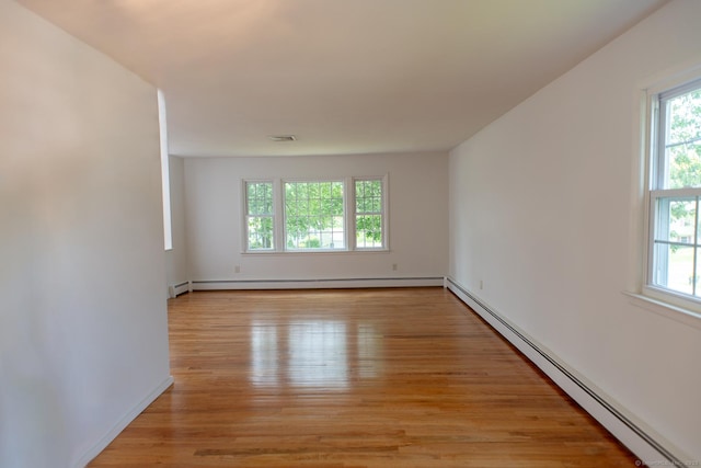 498 Long Hill Ave, Shelton, CT 06484 - unfurnished room featuring a baseboard heating unit, healthy amount of natural light, and light wood-style floors