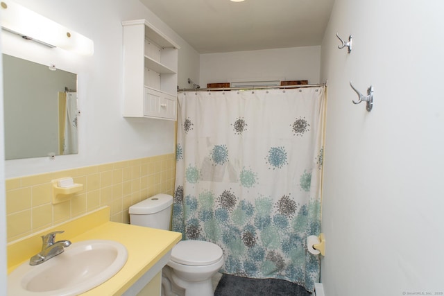 498 Long Hill Ave, Shelton, CT 06484 - bathroom with tile walls, toilet, vanity, a shower with shower curtain, and a wainscoted wall