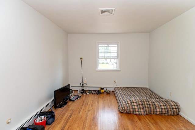 498 Long Hill Ave, Shelton, CT 06484 - unfurnished bedroom featuring wood finished floors and a baseboard radiator