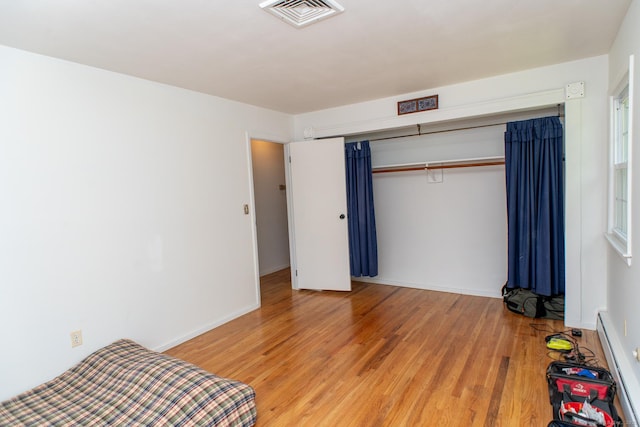 498 Long Hill Ave, Shelton, CT 06484 - unfurnished bedroom with light wood finished floors, baseboard heating, a closet, and baseboards