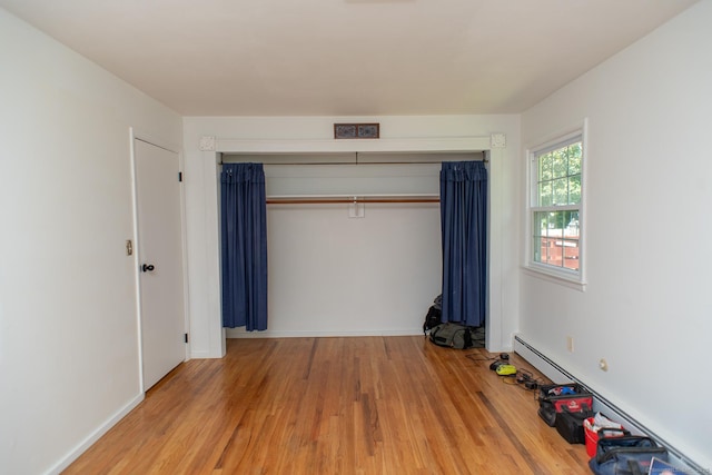 498 Long Hill Ave, Shelton, CT 06484 - unfurnished bedroom featuring wood finished floors, a closet, and a baseboard heating unit