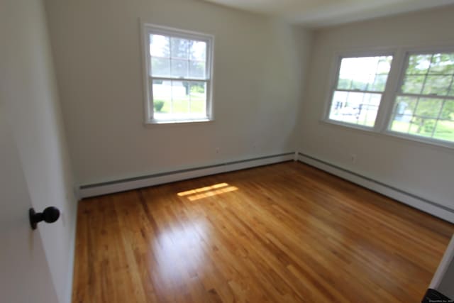 498 Long Hill Ave, Shelton, CT 06484 - spare room with wood finished floors and a baseboard heating unit
