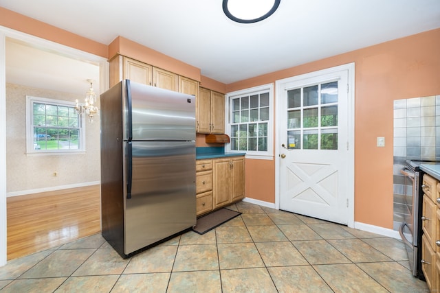 10 Laurel Glen Dr, East Hampton, CT 06424 - kitchen featuring appliances with stainless steel finishes, a chandelier, baseboards, light brown cabinetry, and light tile patterned floors