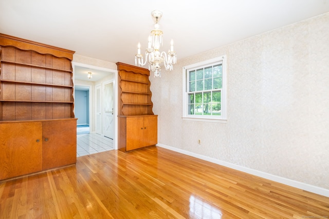 10 Laurel Glen Dr, East Hampton, CT 06424 - empty room featuring wood finished floors, a chandelier, and baseboards